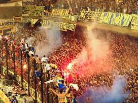 A particularly passionate section of Boca Juniors fans create a hostile atmosphere with the use of flares.
