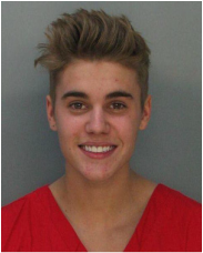 Picture showing Justin Bieber smiling in his police mugshot photograph after being arrested in January 2014.